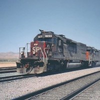 SP8233 an SD40T-2 with an "L" hogger side window, drifts downgrade through Mojave CA