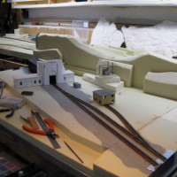 I plonked down a coupla structures to see how things will come together. Even in N, selective compression is a good friend! You can see part of my Royal Gorge layout section behind the East Portal diorama. Only the front main is live & wired, siding & MOW shed spur track are dummies for effect only.