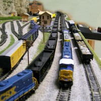 An empty CSX coal train on the left waits as a loaded CSX coal train roars by.