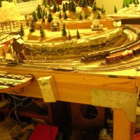 The right hand picture of a two part view of my 4' x 6' table top layout. You can see a portion of the dash board and the vintage South Side Walk Around Controller (SWAC) kit produced by my God Father Don Fieman and built by me from a kit.