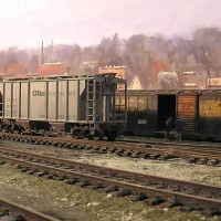 The RS-11 shoves a hopper past the old grounded boxcar