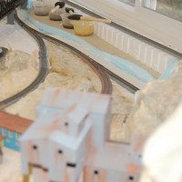 The terrain has had pigments applied, and track reinstalled. Buildings placed for reference

Aerial view looking out towards unlandscaped area