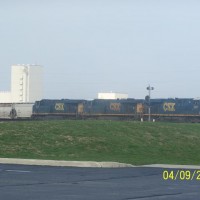 Three ES44DC's and one C40-8W lead a NB autorack train.