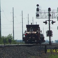 A NS MoW unit finally gets the light to proceed after sitting on an abandoned grain spur for more than a half an hour, after waiting for two TOFC trains, very rare here, epecially two of them.