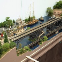 Harbor scene with arch bridges on Lake County Society of Modular Engineers layout