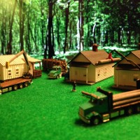 Logging Houses and a Diner printed a Shapeways by southernnscale with three trucks from Showcase Miniatues