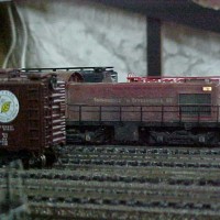 BNO Alco emerges from behind an Atlantic and East Carolina boxcar